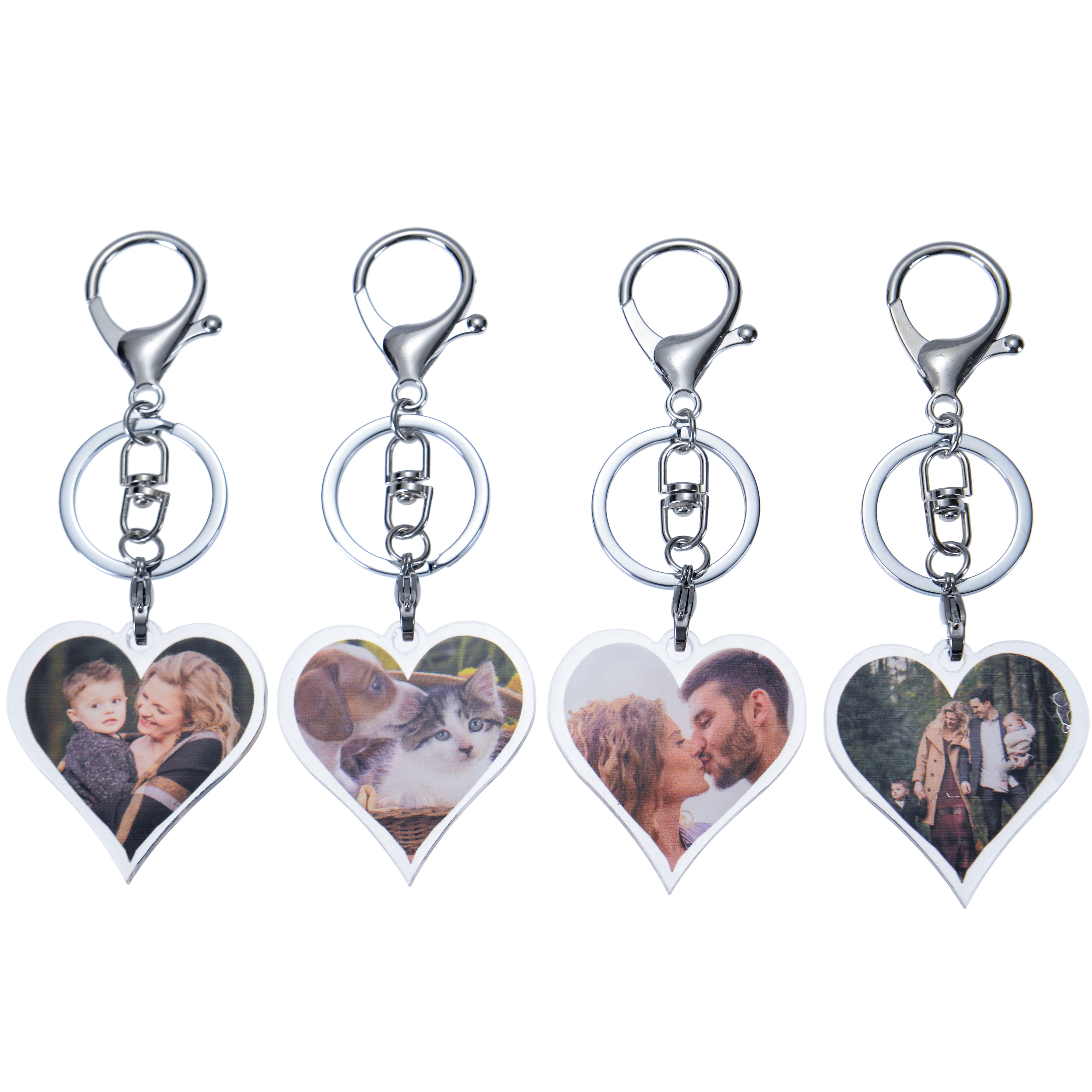 Four silver heart-shaped photo keychains with different images. The keychains have a silver ring and a silver chain.