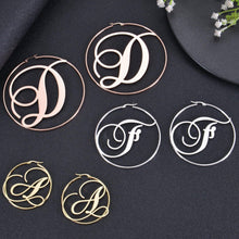 Hinged hoop and clasp detail on script initial earring