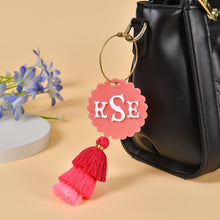 Personalized initial keychain attached to a bag or backpack