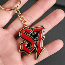 Person holding a colorful personalized logo photo keychain with custom picture