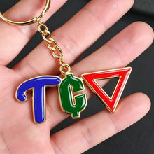 Person holding a colorful personalized photo keychain with custom name
