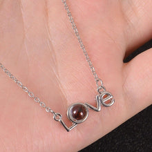 Close-up of Love lettering design on pendant
