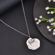 Silver meme pendant necklace with humorous face engraving