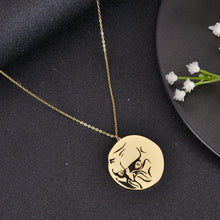 Gold troll face pendant necklace shown against a black background