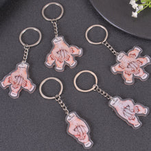 Multiple fist bump keychain designs side by side