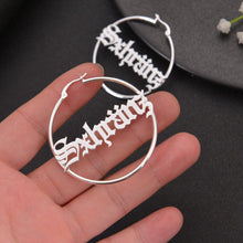 Close-up view of top wire latch closure mechanism on personalized script name hoop earrings.