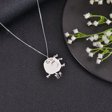 Silver meme pendant necklace with humorous face engraving