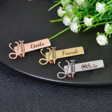 Grouping of rose gold, silver, and gold custom nurse brooches showing finish options and clear engraving contrast.