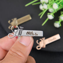 Top-down view showing thin metallic profile and integrated medical symbol charms of personalized nurse brooch pin.
