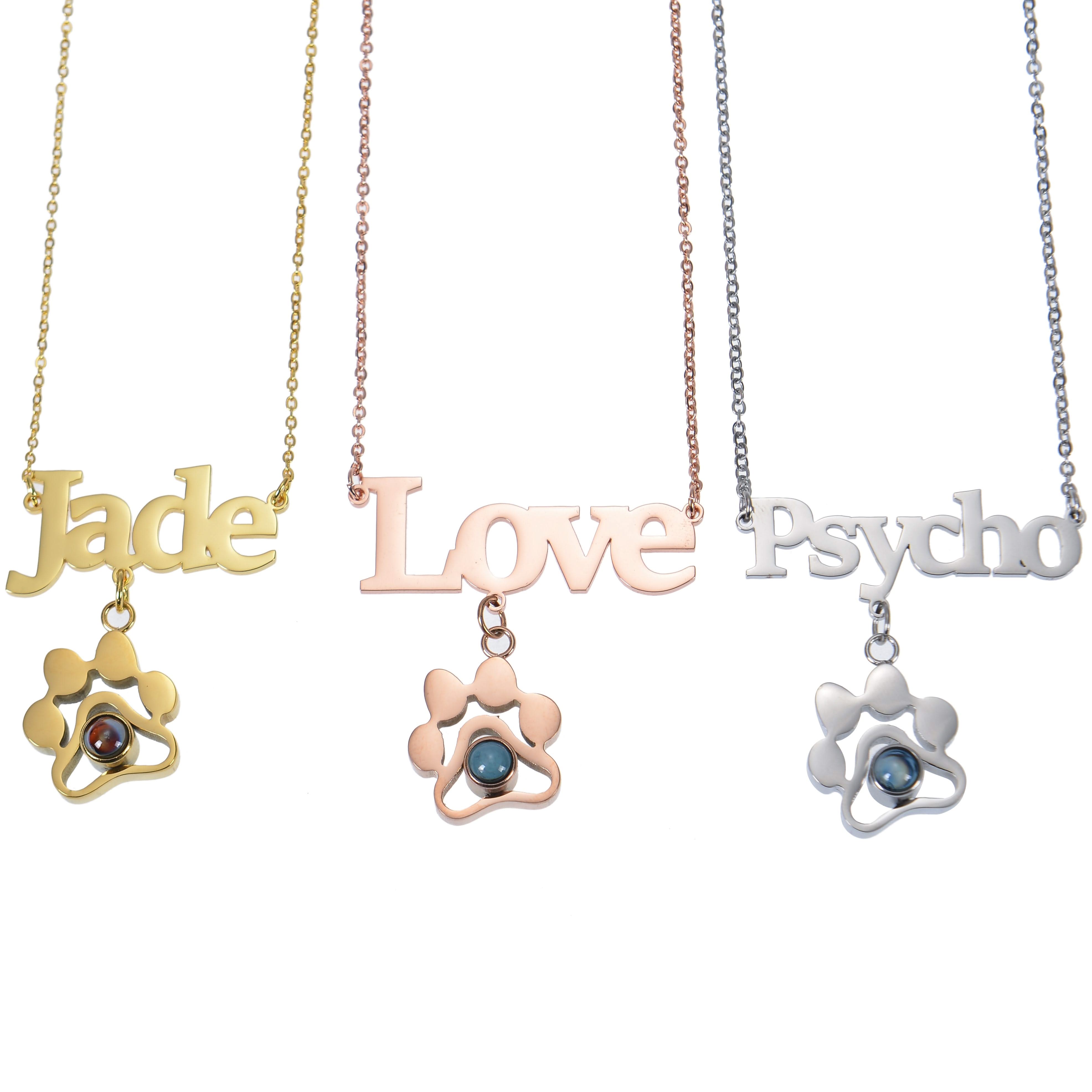Gold, rose gold, and silver paw print necklaces shown together