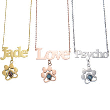 Gold, rose gold, and silver paw print necklaces shown together