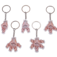 Five fist bump keychain variations shown together