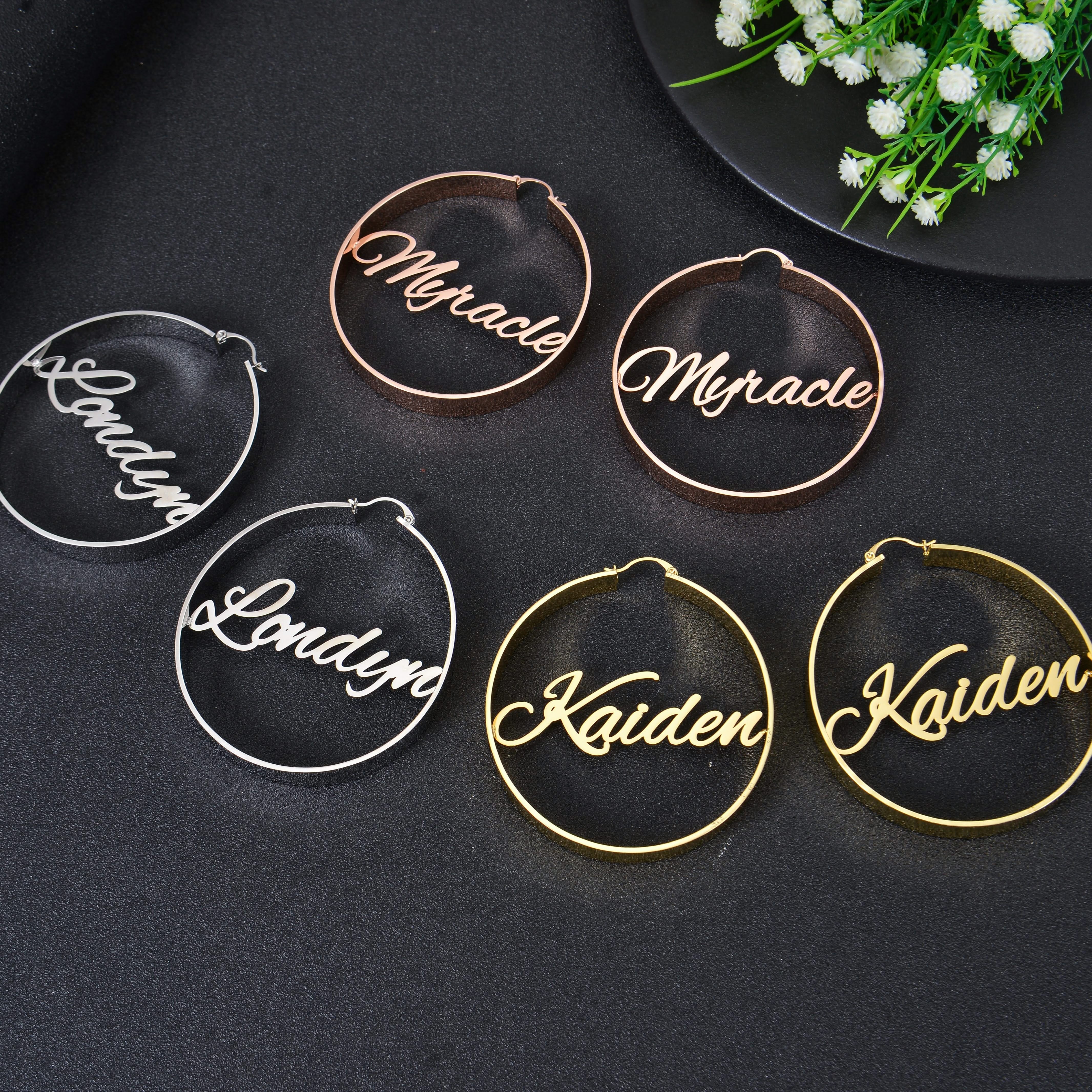 Pendantify personalized name hoop earrings featuring custom cursive script nameplates centered inside smooth round hoops in rose gold, silver, and gold.