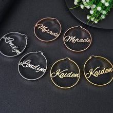 Pendantify personalized name hoop earrings featuring custom cursive script nameplates centered inside smooth round hoops in rose gold, silver, and gold.