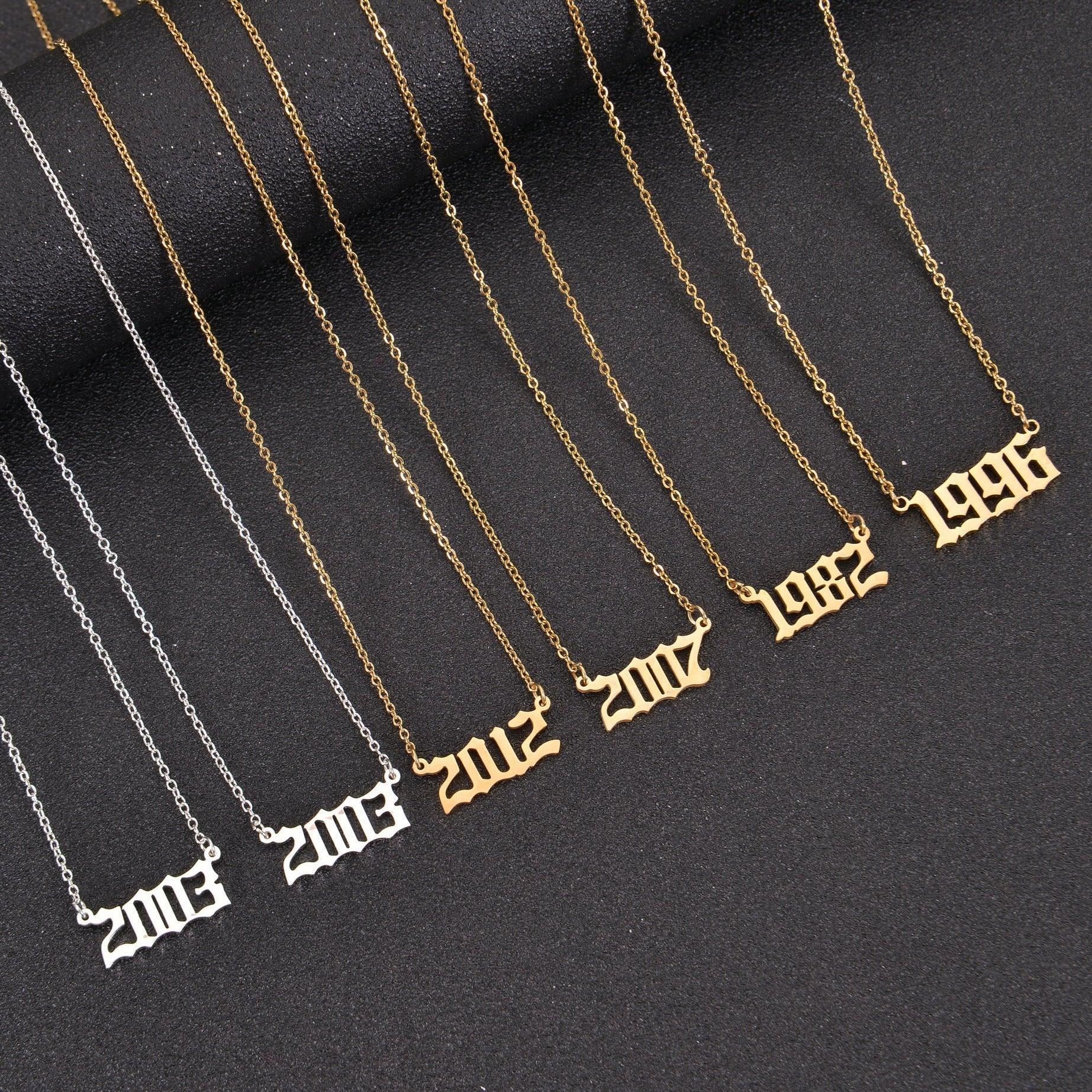 Gold, Silver, and Rose Gold personalized birth year necklaces displayed together.
