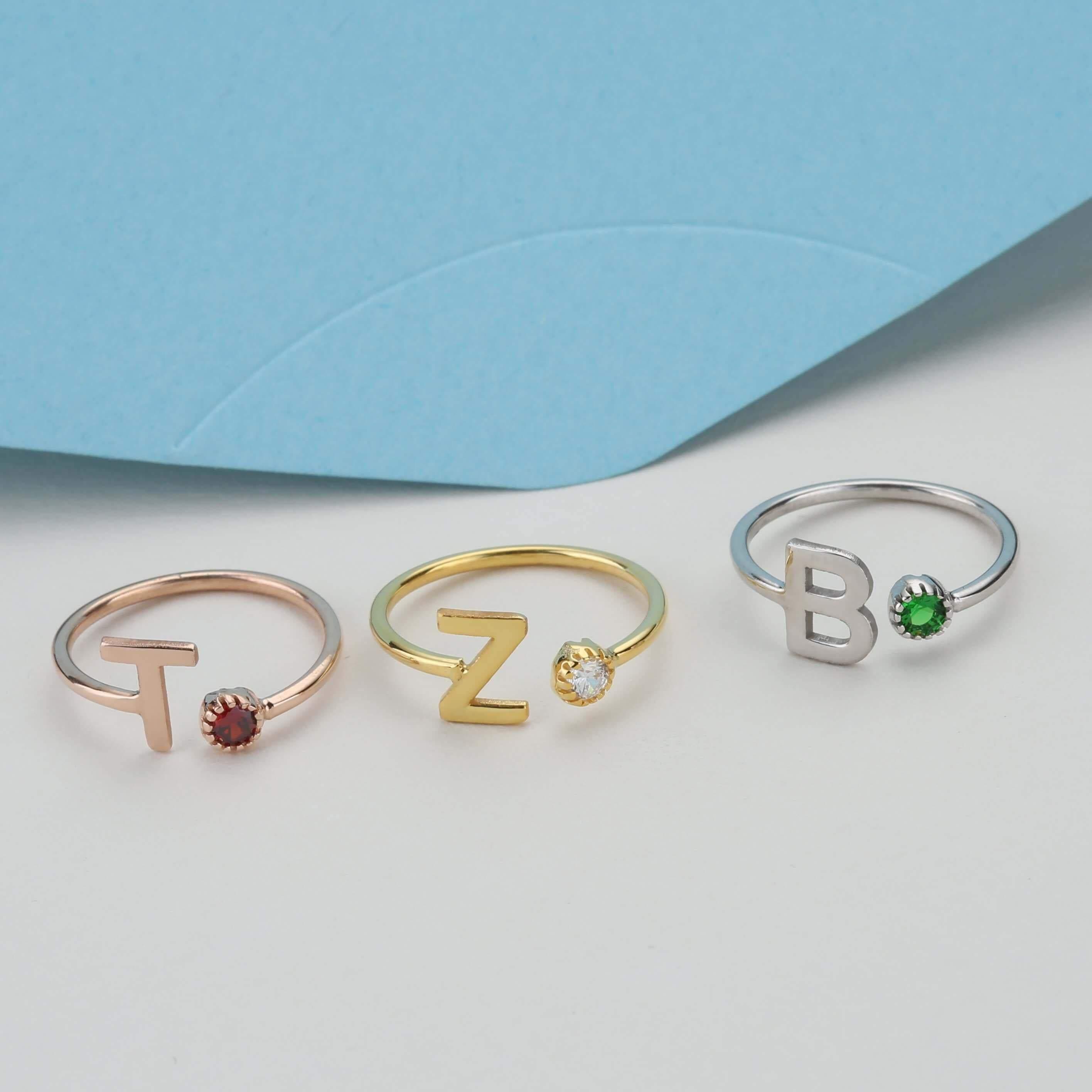 Three color and letter options of custom initial ring side by side