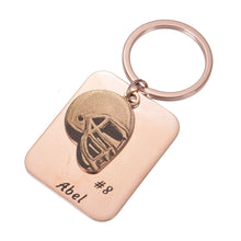 Personalized football helmet keychain attached to a set of keys for everyday use.