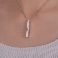 Woman wearing a personalized four sided bar necklace with custom family names engraved on the pendant.