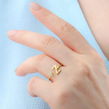 Model wearing gold initial ring as everyday jewelry