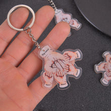 Close-up of engraved kid name on fist bump keychain