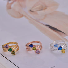 Custom heart birthstone ring laid flat on jewelry display