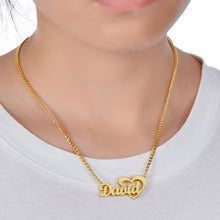 Person wearing gold custom cursive script open heart name necklace for lifestyle scale and neckline placement.