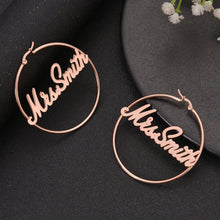 Medium rose gold personalized name hoop earrings with delicate script nameplate reading Mrs. Smith across the frame.