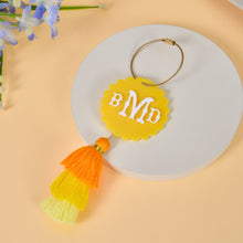 Yellow acrylic monogram keychain with yellow orange tassel