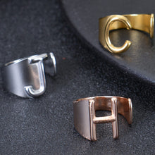 Custom chunky letter ring laid flat on jewelry display