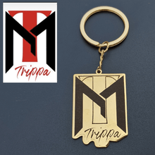 Gold personalized logo keychain featuring a custom brand design and metal keyring
