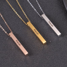 Close-up of a personalized four sided vertical bar pendant showing custom engraved names and dates.