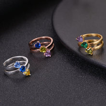 Silver, rose gold, and gold birthstone rings shown together