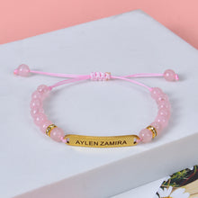 Pendantify custom engraved gold plate nameplate bracelet with pink crystal beads on adjustable pink cord.