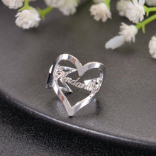 Silver personalized cutout heart ring with custom name script set inside polished heart outline.