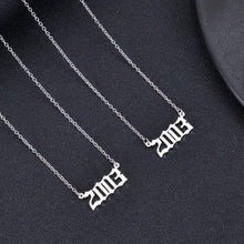 Two silver necklaces with the year 2003 written in a gothic font.