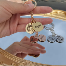 Person carrying a personalized pet photo keychain with engraved pet portrait and custom name