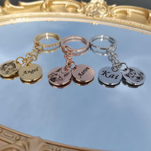 Close view of engraved pet portrait keychain with separate round charm personalized with pet name