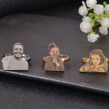 Three silver, rose gold, and gold rings with engraved images of people's faces.