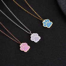 Pink, white, and blue paw necklaces shown together