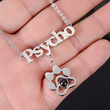 Cursive name pendant detail paired with paw print charm