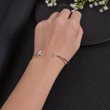 Custom initial bangle bracelet worn on the wrist